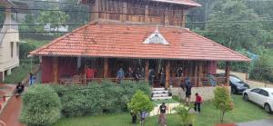 a group of people standing in front of a building at JackRoot Athirappilly in Kallana