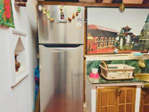 a refrigerator in a kitchen with magnets on it at Newa Home Bhaktapur in Bhaktapur
