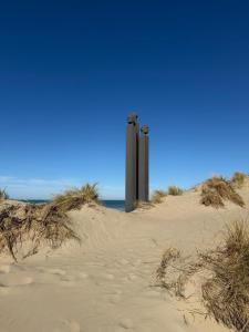 two poles in the sand on a beach at Secret Stay, Wellness Penthouse studio, Privacy, Seaview, Terras, Sauna in Koksijde +53 photos
