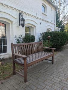 a wooden bench sitting in front of a house at Landhaus Kyritz in Kyritz
