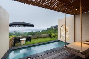 a villa with a swimming pool and a patio at Mount Valley Inn in Kubupenlokan