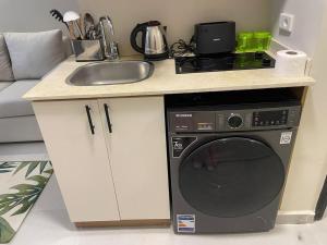 a kitchen with a sink and a washing machine at Florenza Resort- Hurghada in Hurghada
