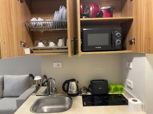 a kitchen counter with a sink and a microwave at Florenza Resort- Hurghada in Hurghada
