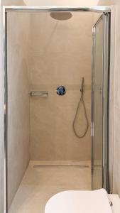 a shower with a glass door in a bathroom at Cefalù Beach Garden House in Cefalù