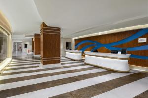 a lobby with a large blue ribbon on the wall at Courtyard by Marriott Hangzhou Wulin at West Lake in Hangzhou +26 photos