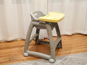 a high chair with a yellow seat on top at Lake, mountain view cottage - near major attractions in Rotorua