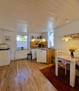 a kitchen with a table and a dining room at Haegerende _Alte Liebe_ in Groß Kirr