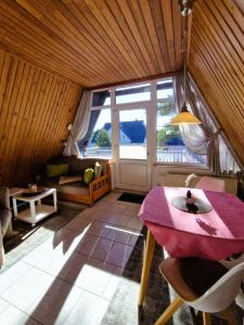a living room with a table and a couch at Haegerende _Seitensprung_ in Groß Kirr