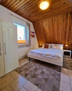 a bedroom with a bed with a wooden ceiling at Haegerende _Seitensprung_ in Groß Kirr