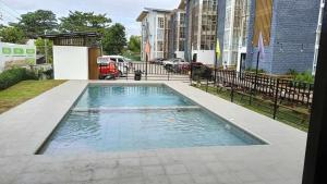 a swimming pool in the middle of a building at Bayanihan Flats 2 in Pajak +11 photos