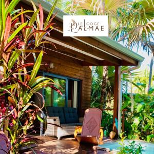 a patio with a house with a sign that readsilage rainmaker at Lodge Palmae - Lodge de charme avec Jacuzzi Privatif en Option - Adults Only in Saint-Pierre +19 photos
