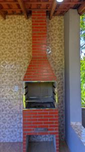 a brick oven with a roof on a patio at Pousada Rancho Dona Lú Solo in Pereira Barreto