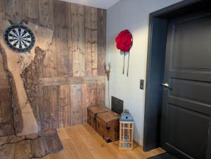 a room with a wooden wall with a door at Gemütliche Waldrandlage in Badenweiler Sehringen Ferienwohnung in Badenweiler