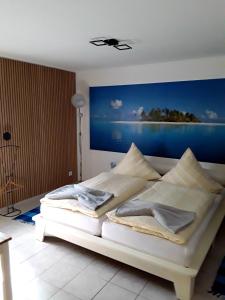 a bedroom with a bed with a painting on the wall at Pension Müller in Barweiler