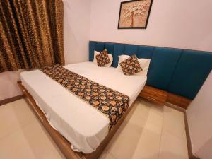 a bed with pillows on it in a room at hotel Atithii in Rīngas