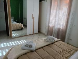 a bedroom with a bed with towels on it at La Capaciota in Capaci +12 photos