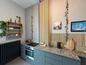 a kitchen with blue cabinets and a counter top at Wohnglück Alte Werft Leer in Leerort +19 photos
