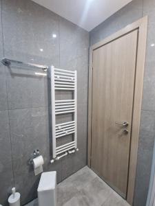 a bathroom with a shower with a toilet and a door at Viktoria Sea View Apartment in Perea +34 photos