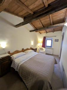 a bedroom with a large bed and a window at Residenza La Torre in Santo Stefano di Sessanio
