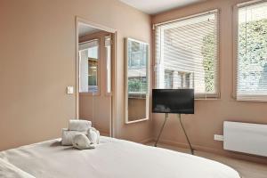 a bedroom with a bed with a teddy bear on it at French house in Paris