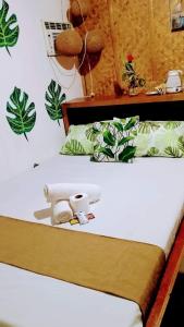 a bedroom with a bed with plants on the wall at Green Sea Turtle in Romblon