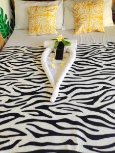 a bed with two heart towels and a flower on it at Green Sea Turtle in Romblon