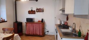 a kitchen with a sink and a stove top oven at L'incantevole vista in Colico