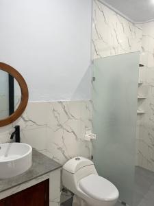 a bathroom with a toilet and a sink at JS Guest House in Seminyak +25 photos