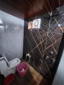 a small bathroom with a toilet and a sink at hotel Atithii in Rīngas