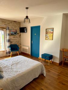 a bedroom with a bed and a blue door at Chambre d´hôtes La Jonchère in Les Herbiers +16 photos