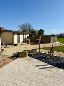 a backyard with a fence and some plants at Chambre d´hôtes La Jonchère in Les Herbiers