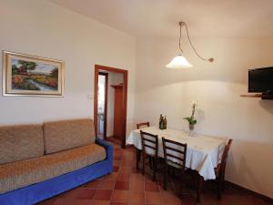 a living room with a table and a couch at Comfortable home with terrace, located in nature in Salecchio