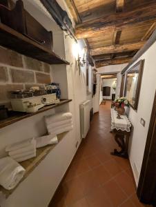 a hallway of a kitchen with towels on a shelf at Residenza La Torre in Santo Stefano di Sessanio +64 photos