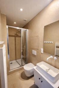 a bathroom with a shower and a toilet and a sink at SLEEP INN - Kyoto Suites South Antwerp in Antwerp +15 photos