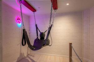a person in a hammock hanging from a wall at love escape "Love Room" in Saint-Paul-Trois-Châteaux