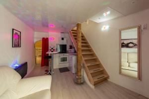 a living room with a spiral staircase in a room at love escape "Love Room" in Saint-Paul-Trois-Châteaux +2 photos
