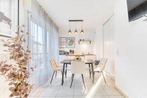 a kitchen and dining room with a table and chairs at L'Écrin Piano, chic near Paris in Asnières-sur-Seine +26 photos