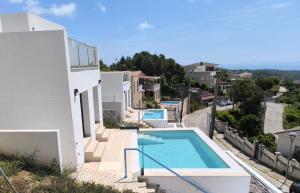a villa with a swimming pool and a street at Les Flors de Cunit Villa Cedra in Cunit