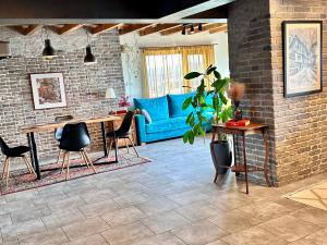 a living room with a blue couch and a table at Studio54 Stunning View plus Free Parking in Veliko Tŭrnovo