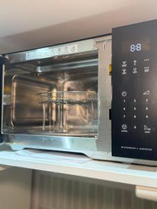 a microwave oven sitting on top of a shelf at Maple Gem in Birmingham