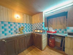 a kitchen with blue and white tiles on the wall at Newa Home Bhaktapur in Bhaktapur +18 photos