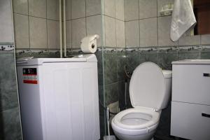 a bathroom with a toilet and a roll of toilet paper at decebal premium apartment in Bucharest