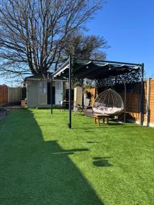 a yard with a hammock and a pavilion at Maple Gem in Birmingham