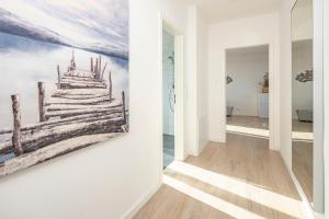 a hallway with a painting hanging on a wall at Ostsee Suite 1 - Strandperle in Niendorf