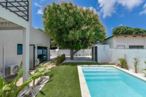 a swimming pool in the yard of a house at Loveli Stay Aruba in Oranjestad