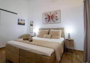 a bedroom with a large bed with two lamps at Loveli Stay Aruba in Oranjestad +41 photos