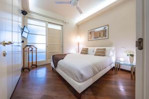 a bedroom with a large white bed and a window at Cavour Suite Luxury in Bologna