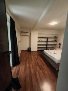 a bedroom with a bed and a wooden floor at L'Amplesso xxx in Bari