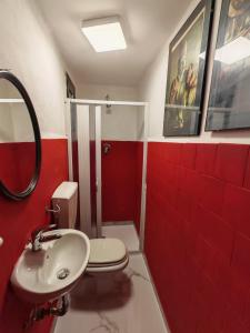 a bathroom with a white toilet and a sink at L'Amplesso xxx in Bari