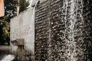 a water fountain in front of a brick wall at Parkhotel Schoenegg in Grindelwald